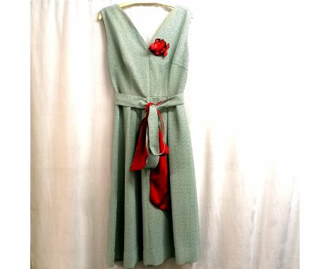 1950/60's pale blue crimplene mid length dress with red faced sash. Size 12.&nbsp;In good condition but need washing