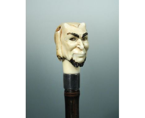 A late 19th century ivory articulated cane handle, in the form of Pan's head, the silver collar London 1886, with mechanism b