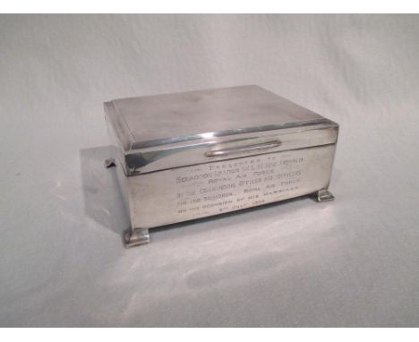 A silver cigarette box, the front inscribed 'Presented to Squadron Leader W.L.M. MacDonald Royal Airforce by the Commanding O