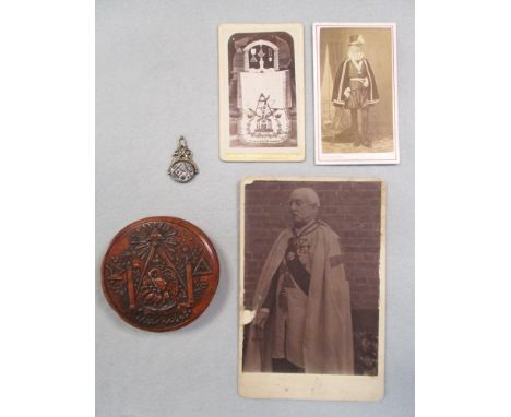 A 19th century French Masonic burr wood circular snuff box with emblems to decorate the cover, the interior with shell lining