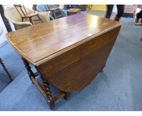 A LARGE OAK BARLEY TWIST GATE LEG TABLE  