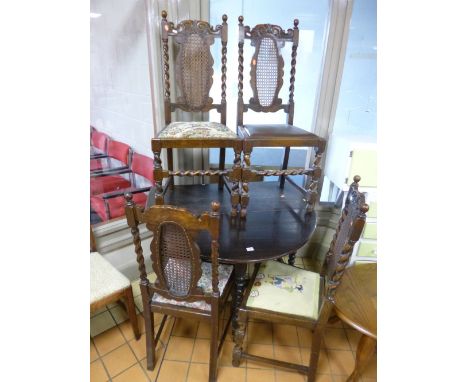 AN OAK GATE LEG TABLE, with bobbin turned supports and four oak dining chairs with barley twist detail and canework backs (5)