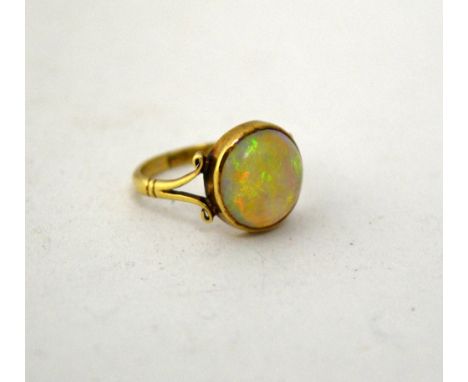 AN OPAL RING, with circular shape opal to the two pronged tapered band, stamped 9ct, ring size N1/2 