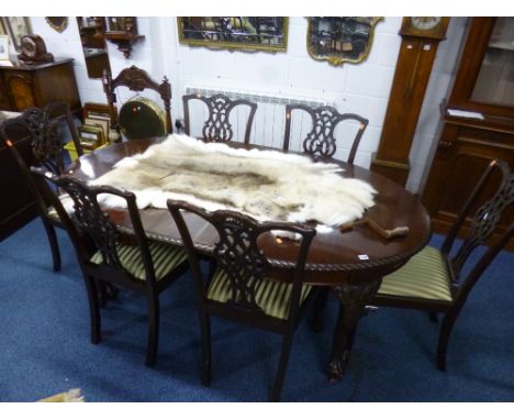 AN EARLY 20TH CENTURY CARVED MAHOGANY DINING SUITE, comprising extending table, (one extra leaf) and six Chippendale style ch
