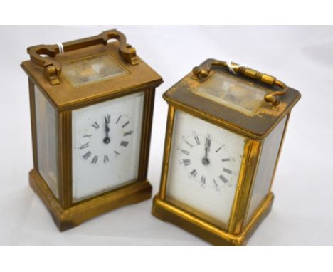 TWO CASED BRASS CARRIAGE CLOCKS, with white enamel dials with Roman numerals, bevelled glass on bracket plinth, both approxim