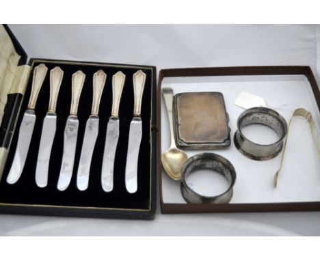 SIX CASED SILVER HANDLED BUTTER KNIVES, together with silver napkin rings, teaspoons, nips and engine turned cigarette case