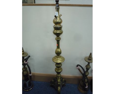 A TALL BRASS HOOKAH PIPE, base with embossed scroll decoration to tripod base on three claw and ball feet and engraved detail