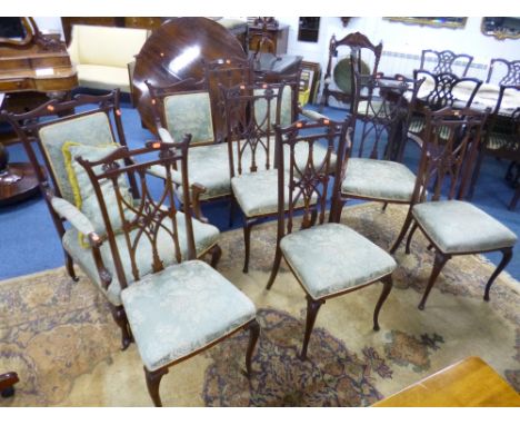 AN EDWARDIAN SEVEN PIECE PARLOUR SUITE, with carved mahogany frame and green upholstery comprising two seater sofa, two armch