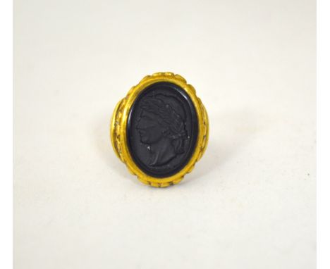 A CAMEO RING, depicting a Roman man in profile to the fancy tapered surround, ring size Q