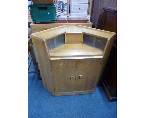 A LIGHT OAK CORNER WRITING DESK, with cupboard base 