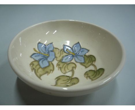 A MOORCROFT POTTERY FOOTED TRINKET DISH, 'Campanula' pattern, impressed 'Moorcroft' to base, diameter approximately 11.5cm 
