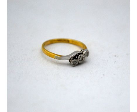 AN 18CT GOLD DIAMOND RING, with three single cut diamonds on a twisted shank, stamped 18ct and PLAT 