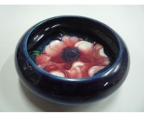 A MOORCROFT POTTERY TRINKET DISH, 'Anemone' pattern, impressed marks, diameter approximately 11.5cm (restorations)  