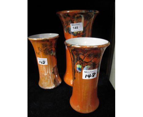 Pair of Staffordshire pottery Wilkinson Limited orange lustre flared vases together with a matching larger vase. (3)
