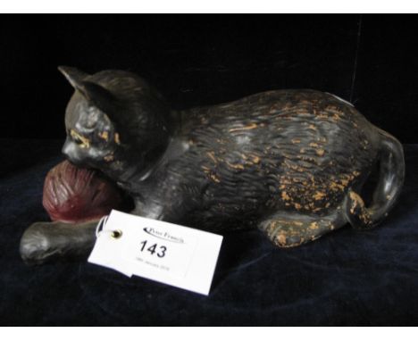 A Bretby pottery cat playing with red ball of wool with glass eyes. Impressed marks to base no. 1518. 