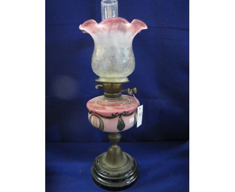 Early 20th century art nouveau design brass double burner oil lamp with painted glass reservoir on a brass pedestal with cera
