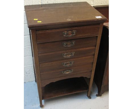 Early 20th century mahogany five drawer music cabinet with under tier on ceramic casters. 