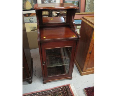 Early 20th century mahogany music cabinet with over shelf and mirror back. 