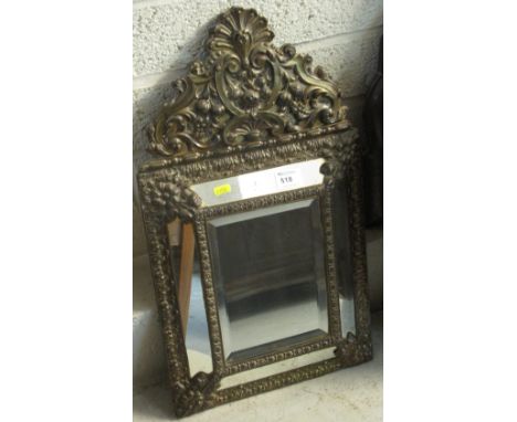 Relief scroll and foliate decorated bevel plate mirror. 