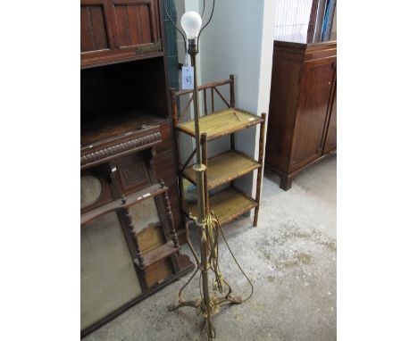 Early 20th century brass telescopic standard lamp with claw feet to the triform base. 