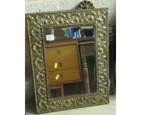 Brass relief shell and foliate design bevel plate mirror. 
