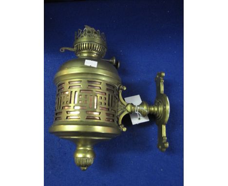 Brass double burner oil lamp in pierced brass wall fitting. 
