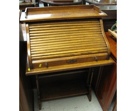 Early 20th century small oak s roll top desk with under shelf. 