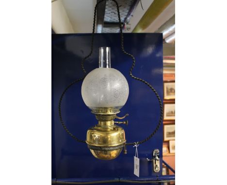 Cast metal and brass hanging oil lamp with funnel and florally etched globular shade. 