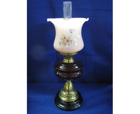 Early 20th century brass double burner oil lamp having ceramic reservoir on brass pedestal with ceramic base, printed glass s