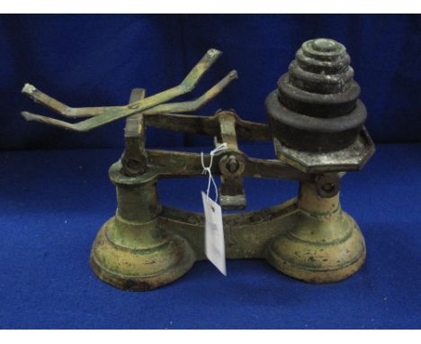 Set of cast iron kitchen type scales with six graduated weights. 