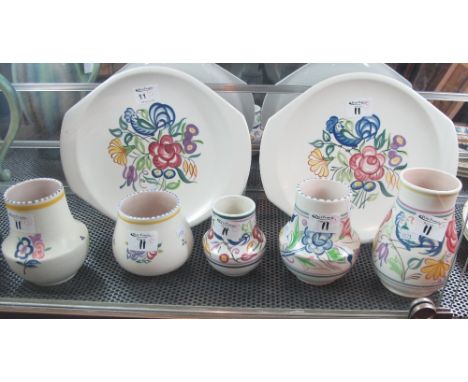 A group of Poole pottery items to include pair of dishes and five various vases, all with painted floral decoration and print