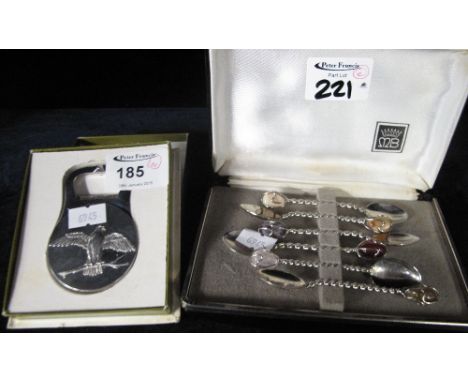 Cased set of plated gem set tea spoons with Christofle bird and palm tree design bottle opener in box. (2)
