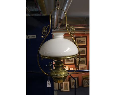 Brass art nouveau style hanging oil lamp with cream opaline glass shade. Registration number 572522. 