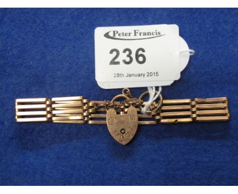 9ct gold four bar gate bracelet with heart shaped locket stamped '9ct'.  CONDITION REPORT; 14 grams