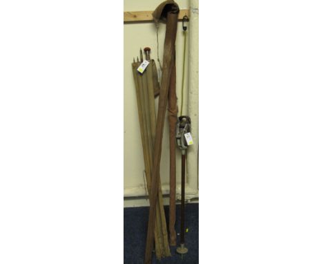Vintage shooting stick and three vintage Green Heart fishing rods. 