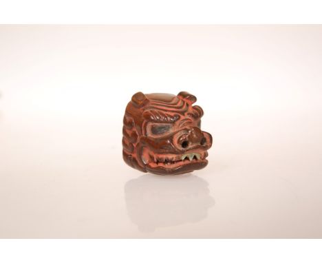 A JAPANESE CARVED WOOD MASK NETSUKE, with pinned jaw. 28mm wide