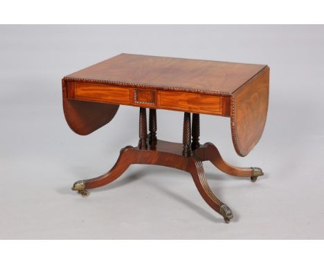 A GEORGE IV MAHOGANY AND ROSEWOOD SOFA TABLE, the well figured top with bead and reel edge, fitted with a pair of frieze draw