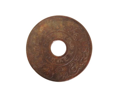 A CHINESE JADE BI DISC, decorated to each side with a band of calligraphy within a broader band of astrological symbols. 14.7