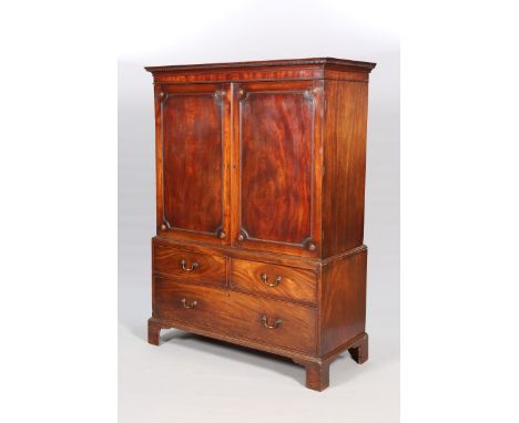 A GEORGE III MAHOGANY PRESS, the moulded cornice above dentil moulding over a pair of fielded panel doors with roundel to eac
