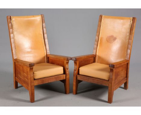 ROBERT THOMPSON OF KILBURNA PAIR OF MOUSEMAN OAK ARMCHAIRS, each with slung leather back and enclosed boarded arms, with carv