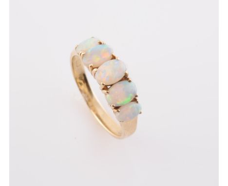 AN OPAL RING, the five graduating oval cut opals each claw set in a stepped design pierced mount between solid tapering shoul