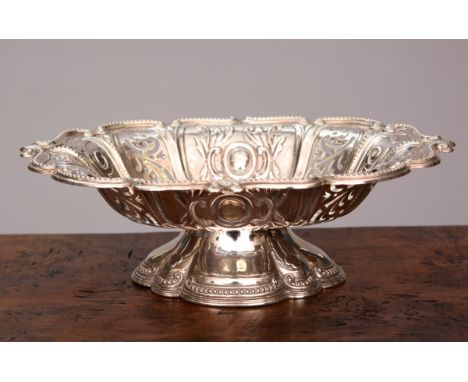 A LATE VICTORIAN SILVER DISH, George Howson, Sheffield 1900, chased with scrolls and with pierced panels, raised on a moulded