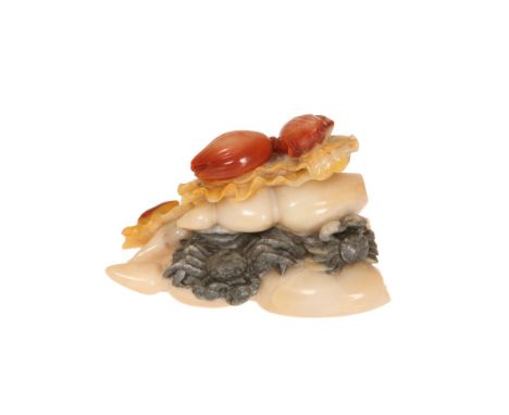 A CHINESE JADE CARVING, PROBABLY 19th CENTURY, of buds, shells and crabs, in tones of pale celadon, spinach and russet, two c