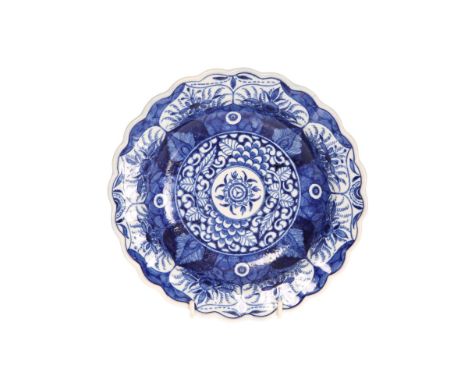 A WORCESTER FIRST PERIOD KANGXI LOTUS PATTERN PLATE, c. 1770, with characteristic decoration and wavy edge, pseudo Kangxi mar