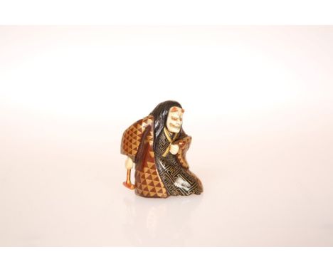 A JAPANESE LACQUERED NETSUKE OF A NOH ACTOR, carved in the role of Hannya, signed, probably 19th Century. 40mm