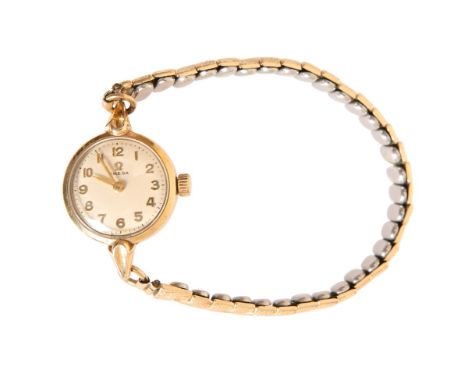 A VINTAGE LADY'S OMEGA WRIST WATCH, with circular dial and expanding bracelet, with guarantee dated 25.9.59. Case 20mm wide