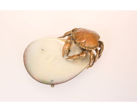 AN UNUSUAL PATINATED BRASS AND MOTHER-OF-PEARL CRAB DISH, the brass crab applied to one end of the shell, raised on four feet