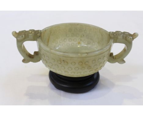 A CHINESE JADE CENSER, 18TH/19TH CENTURY, carved with panels filled with 'bosses' and dragon head handles, on a hardwood stan