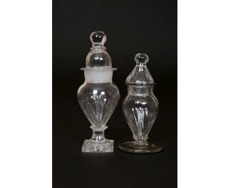 TWO ENGLISH GLASS DRY MUSTARDS, LATE 18th century, the taller with ball finial over a domed cover, the baluster body part-flu