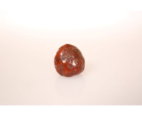 A JAPANESE WALNUT NETSUKE, carved with a bird in flight, 19th Century. 31mm